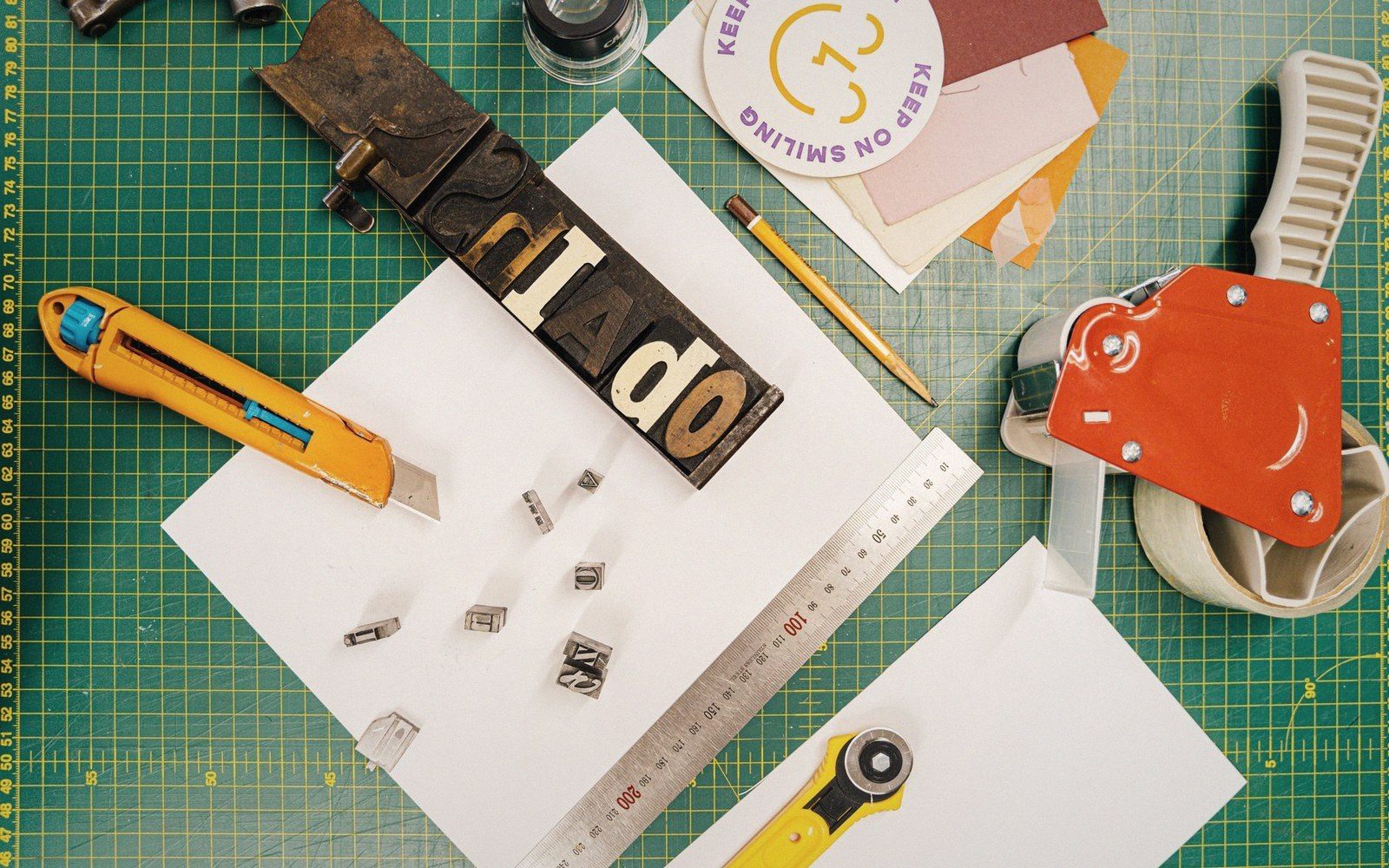 Adhesive screentone sheets and a scalpel on a cutting mat